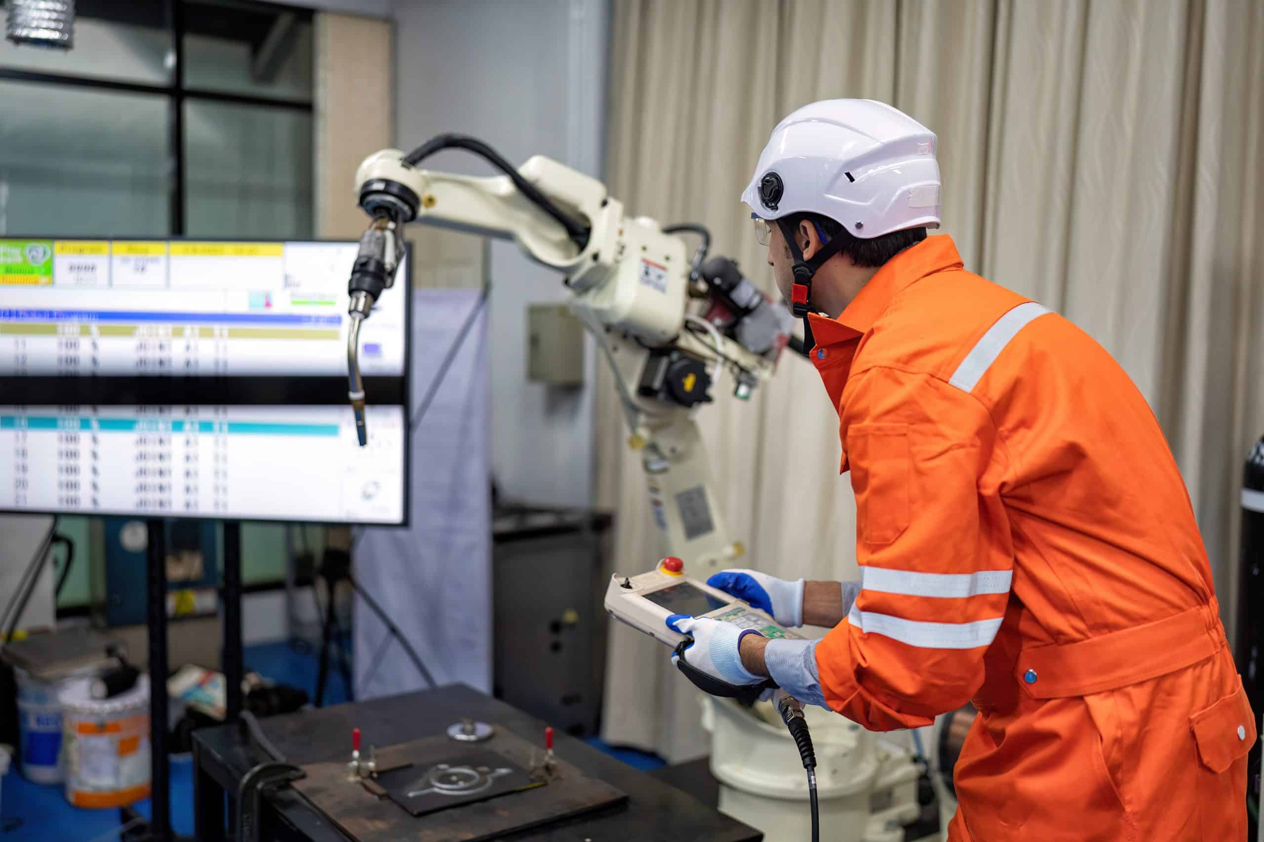 Technical team maintaining an industrial robot